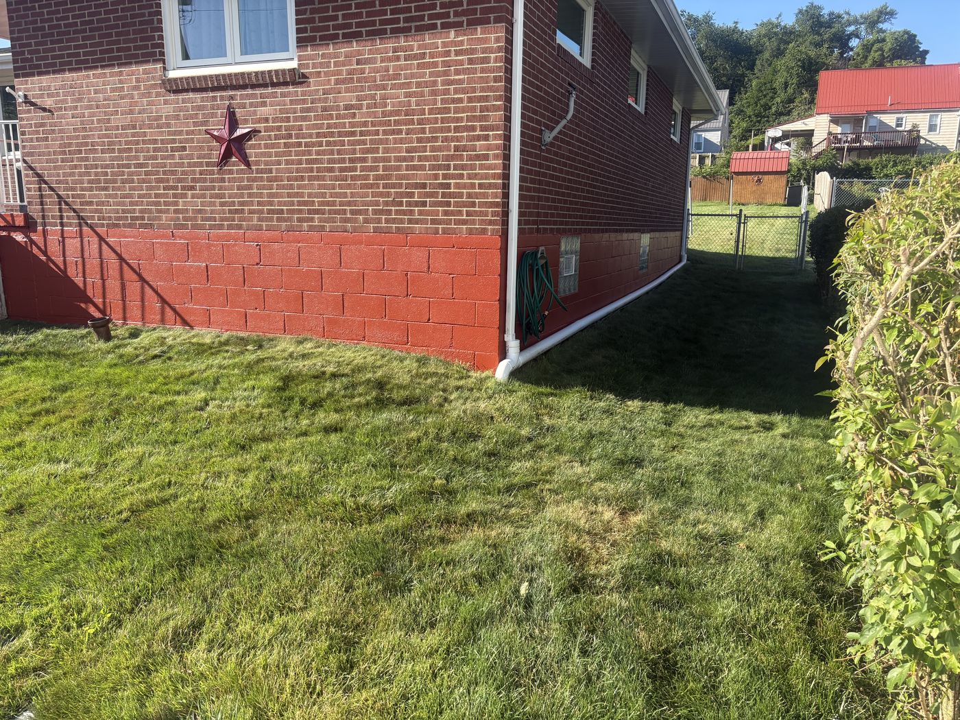 The same foundation finished in an even brick red, cut clean against the brickwork