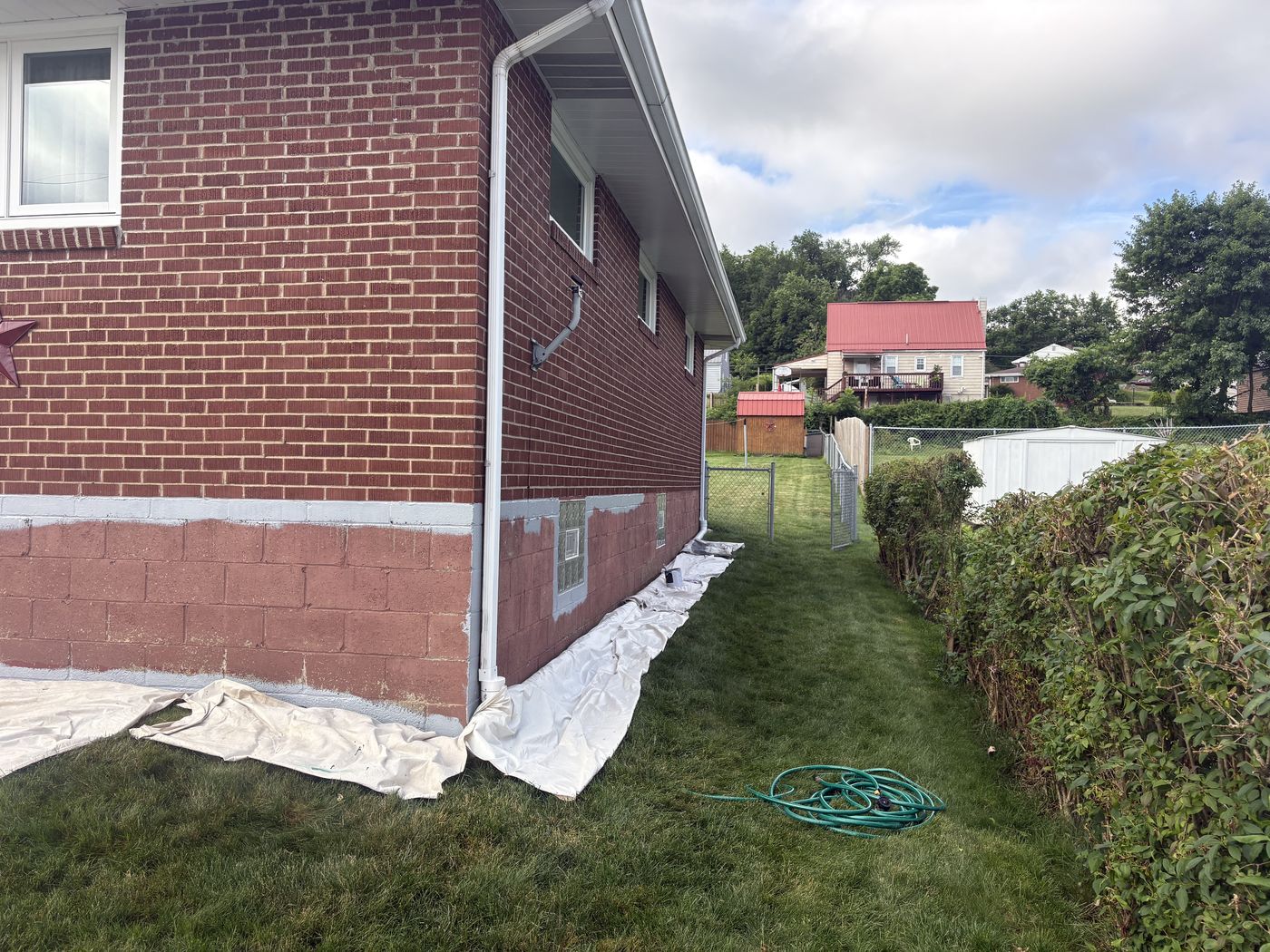 The block foundation part-way through prep, old faded red patched with grey filler